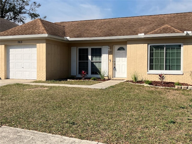 ranch-style house featuring a garage and a front yard