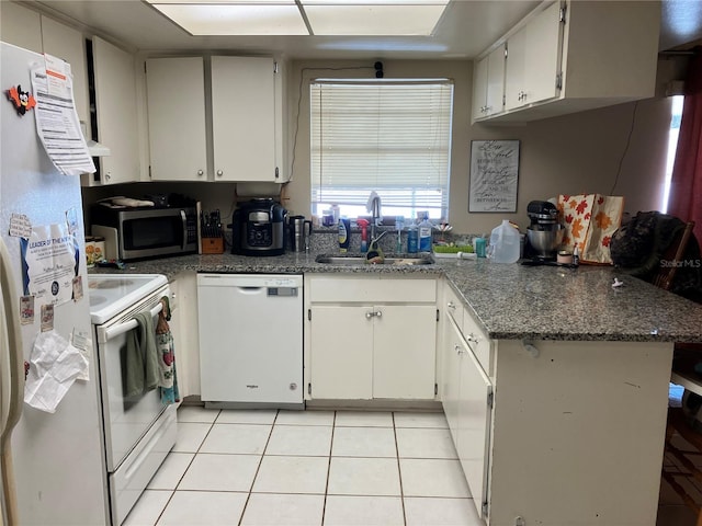 kitchen featuring white cabinetry, sink, white appliances, and light tile patterned floors