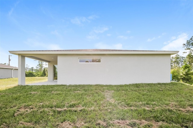 view of side of home with a yard