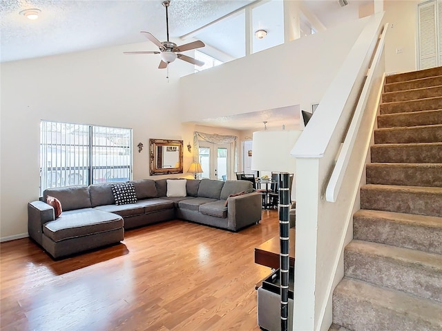 living room featuring ceiling fan, high vaulted ceiling, and hardwood / wood-style floors