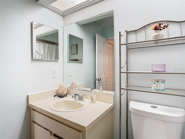 bathroom with vanity and toilet