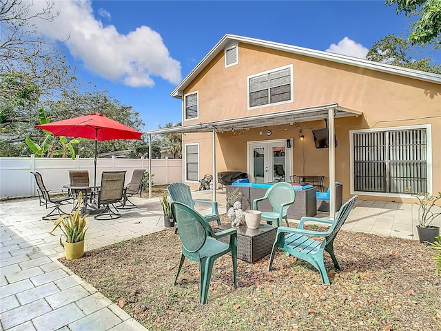 rear view of house featuring a patio and french doors