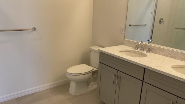 bathroom with vanity, toilet, and walk in shower