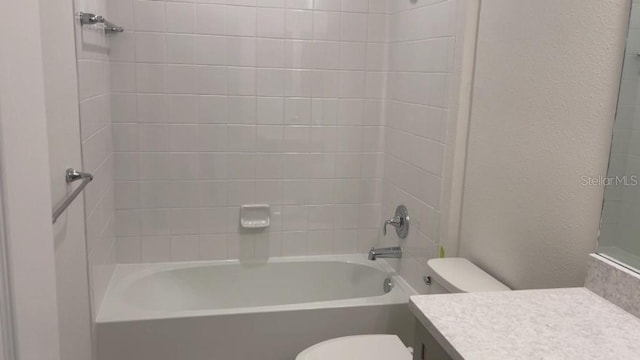 full bathroom featuring vanity, toilet, and tiled shower / bath combo