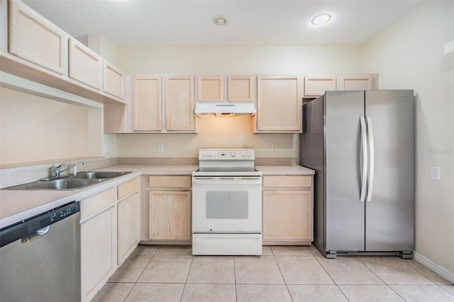 kitchen featuring light tile patterned flooring, appliances with stainless steel finishes, sink, and light brown cabinets