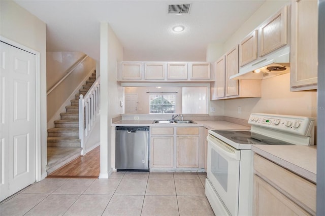 kitchen featuring light brown cabinets, sink, stainless steel dishwasher, and white range with electric stovetop