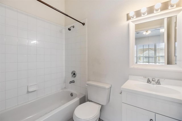 full bathroom with tiled shower / bath combo, vanity, and toilet