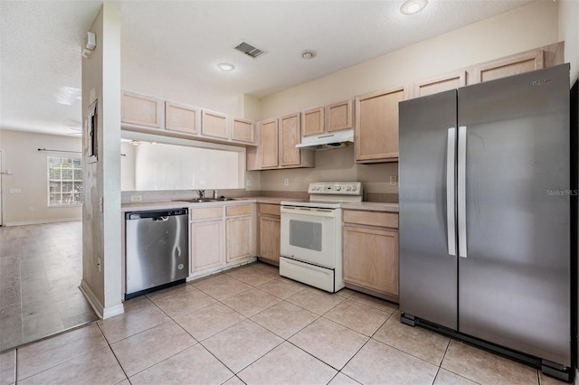 kitchen featuring visible vents, stainless steel appliances, light brown cabinets, and under cabinet range hood