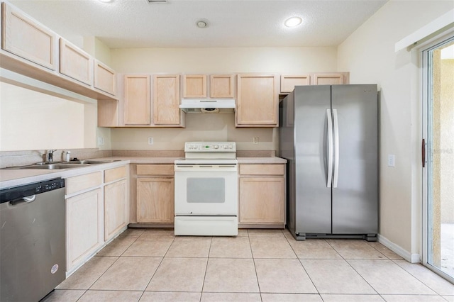 kitchen with light brown cabinets, under cabinet range hood, stainless steel appliances, and light countertops