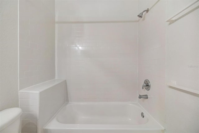 full bathroom featuring tub / shower combination and toilet
