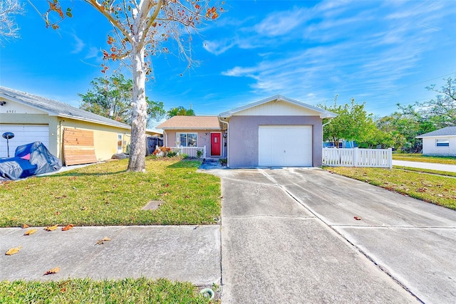 ranch-style home featuring a garage and a front lawn