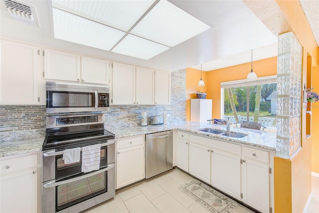 kitchen with sink, stainless steel appliances, hanging light fixtures, and white cabinets