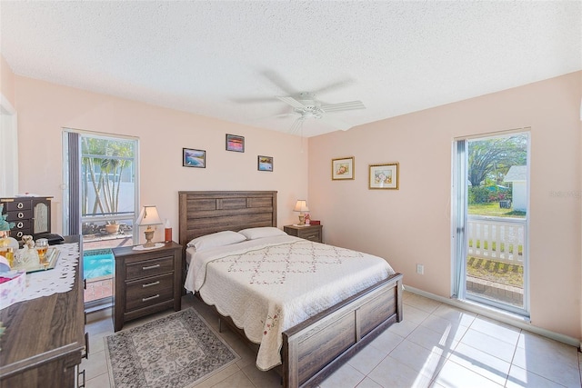 tiled bedroom with multiple windows, access to exterior, a textured ceiling, and ceiling fan