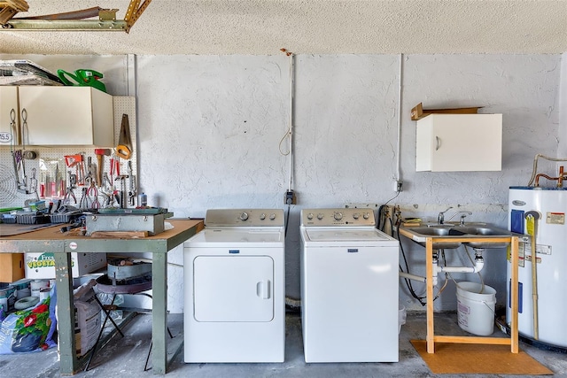 clothes washing area with sink, separate washer and dryer, electric water heater, and a workshop area