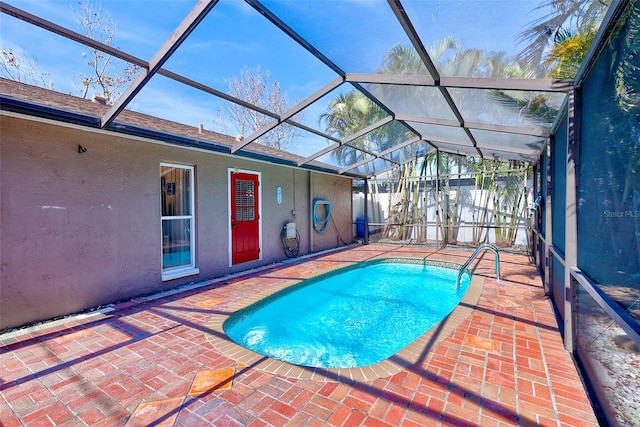 view of pool with a patio and glass enclosure