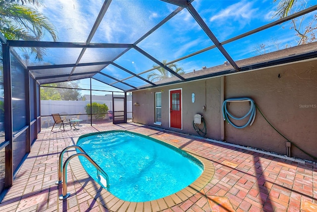 view of swimming pool with a patio and glass enclosure