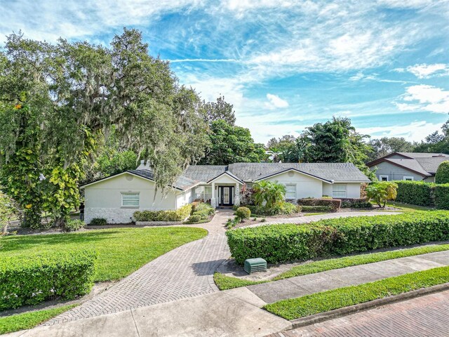 ranch-style house with a front lawn