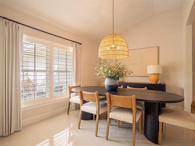 tiled dining area with lofted ceiling