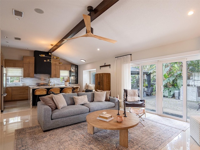 living room featuring lofted ceiling with beams and french doors