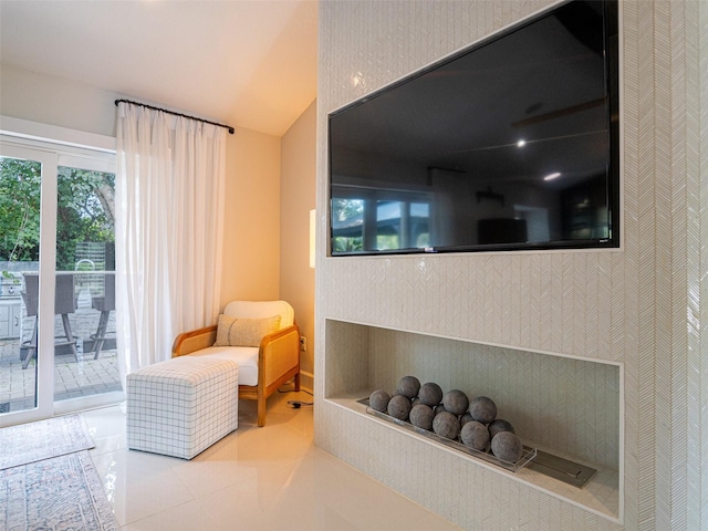 living area featuring light tile patterned flooring and vaulted ceiling