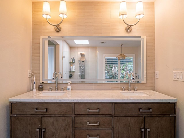 bathroom with vanity and a skylight