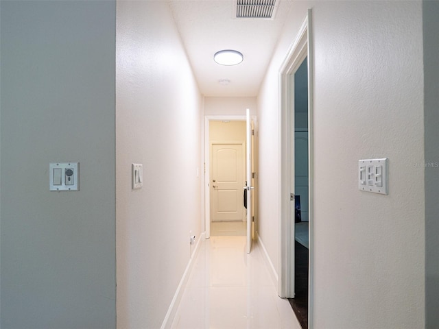 corridor with light tile patterned floors