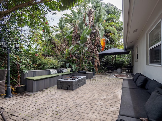 view of patio featuring an outdoor living space with a fire pit