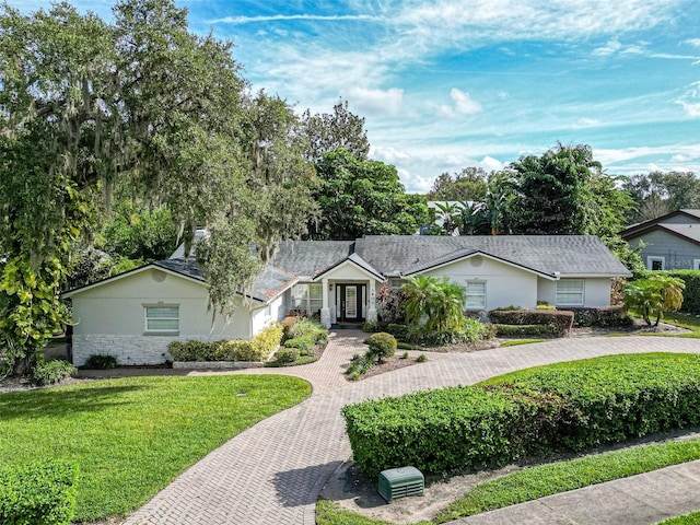 ranch-style home featuring a front yard