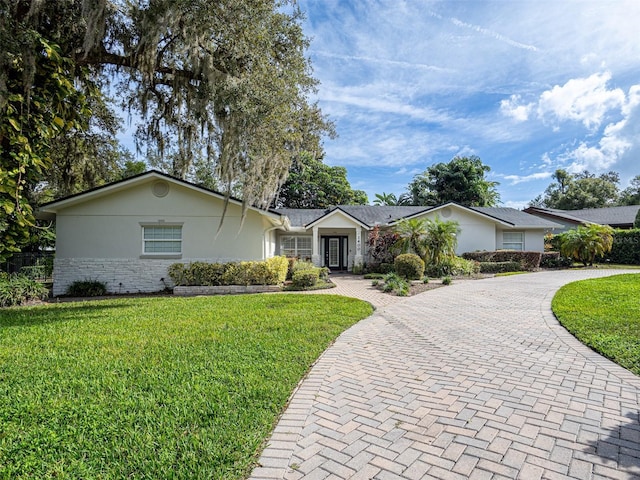 ranch-style house with a front lawn