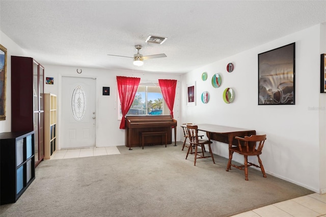 interior space featuring ceiling fan and a textured ceiling