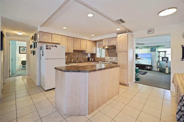 kitchen featuring light tile patterned floors, white appliances, a center island, and light brown cabinets