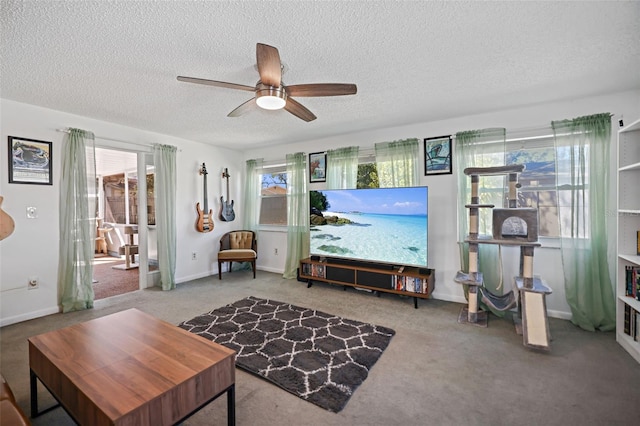 living room with ceiling fan, a textured ceiling, and carpet flooring