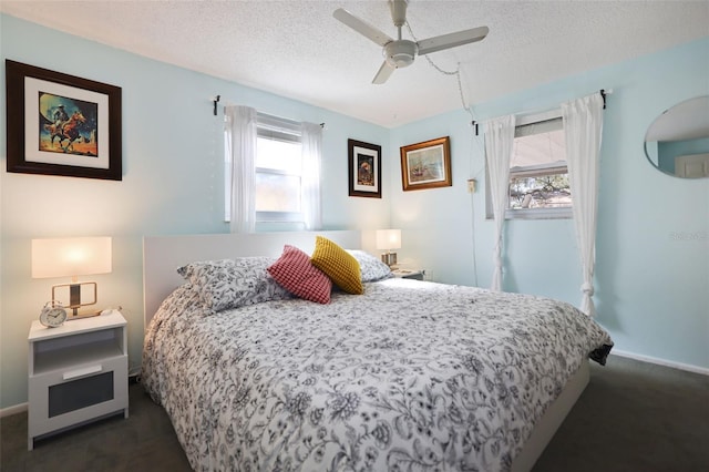 carpeted bedroom with ceiling fan and a textured ceiling