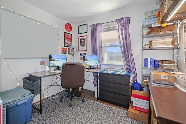 office with dark hardwood / wood-style flooring and a textured ceiling