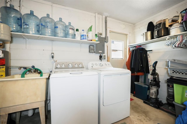 clothes washing area with sink and washer and dryer