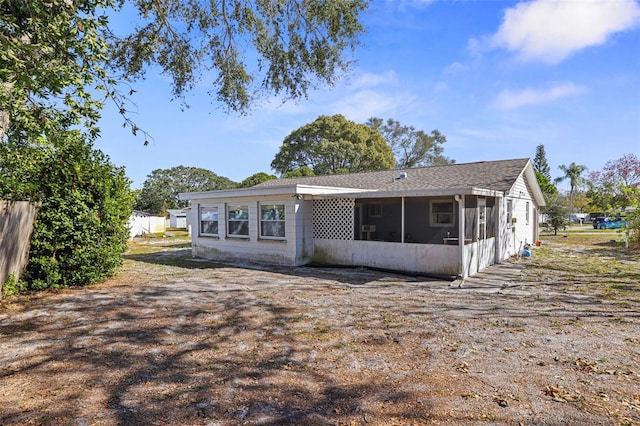 rear view of property with a sunroom