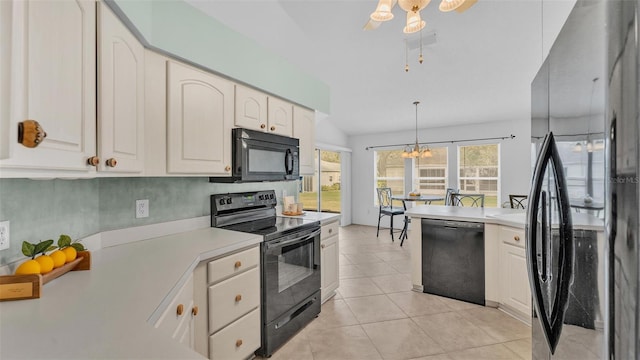 kitchen with black appliances, plenty of natural light, light countertops, and hanging light fixtures