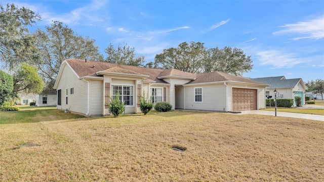ranch-style home featuring a garage, concrete driveway, and a front lawn