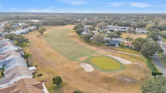 aerial view of property and surrounding area with nearby suburban area and a local golf course