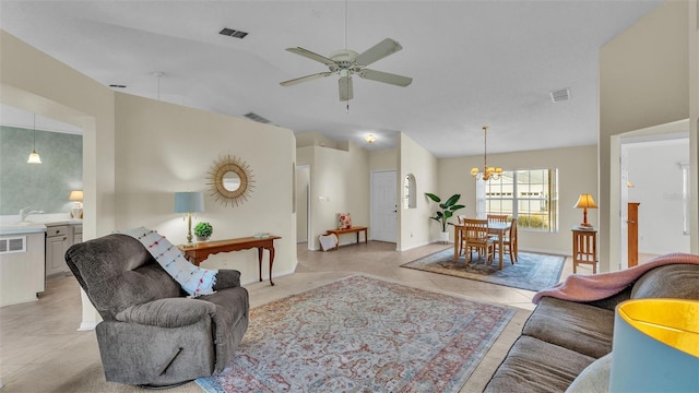 living room with lofted ceiling, a ceiling fan, a chandelier, light tile patterned floors, and baseboards