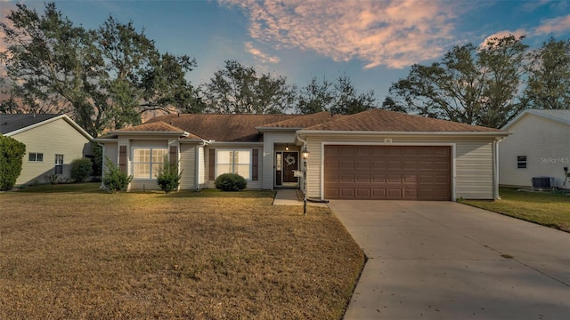 single story home with central AC unit, a garage, concrete driveway, a front lawn, and a chimney