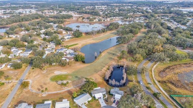 aerial view of property's location with a large body of water and nearby suburban area