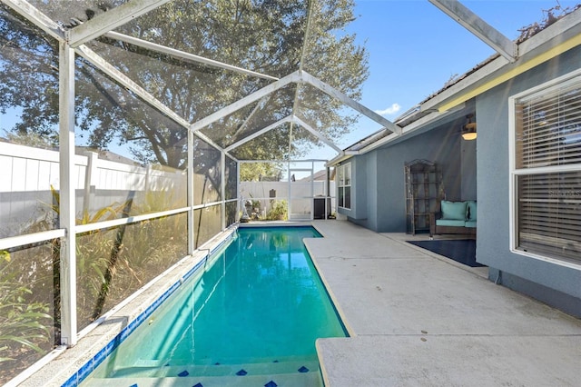 view of swimming pool featuring a lanai and a patio area