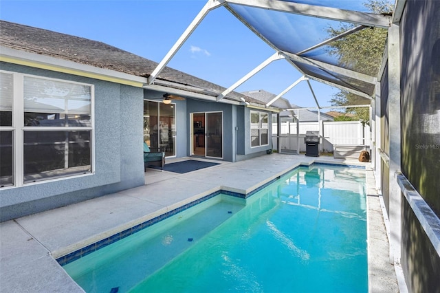 view of swimming pool featuring a patio, a lanai, and grilling area