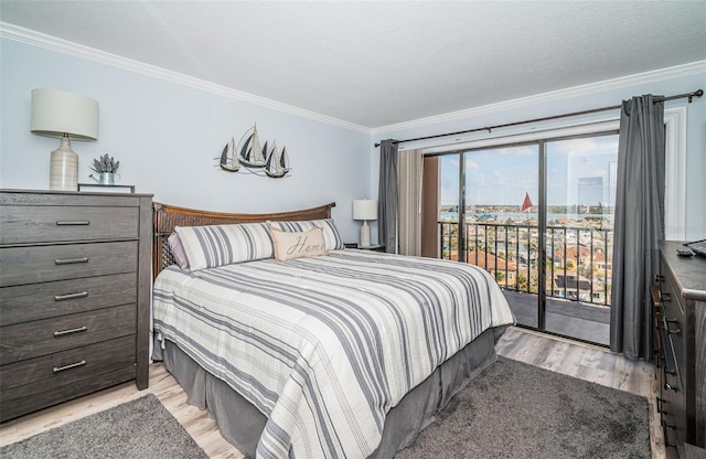 bedroom with ornamental molding, access to exterior, light hardwood / wood-style floors, and a textured ceiling