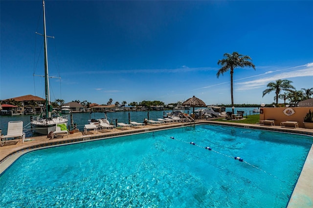 view of swimming pool with a water view