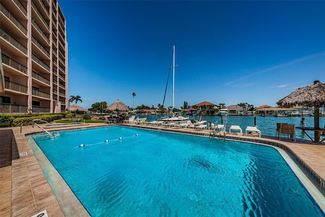 view of swimming pool featuring a water view