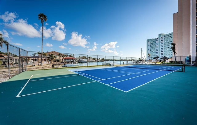 view of sport court with a water view and basketball court