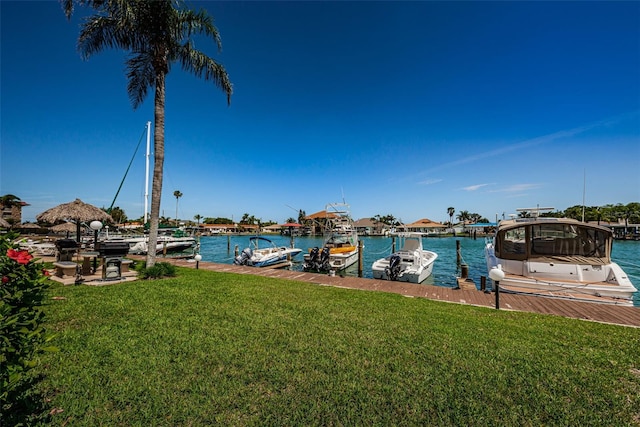 dock area featuring a water view and a yard