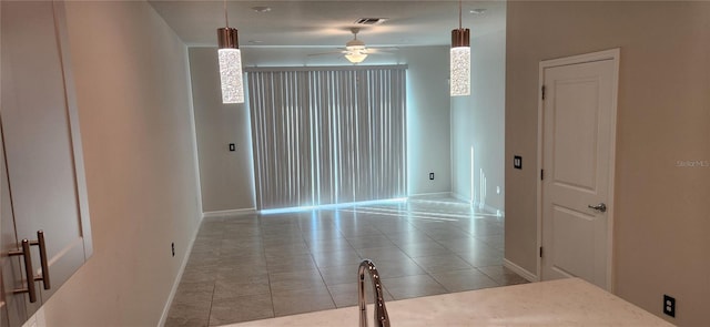 spare room featuring ceiling fan and light tile patterned flooring